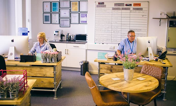 man-and-women-work-on-computers-in-office